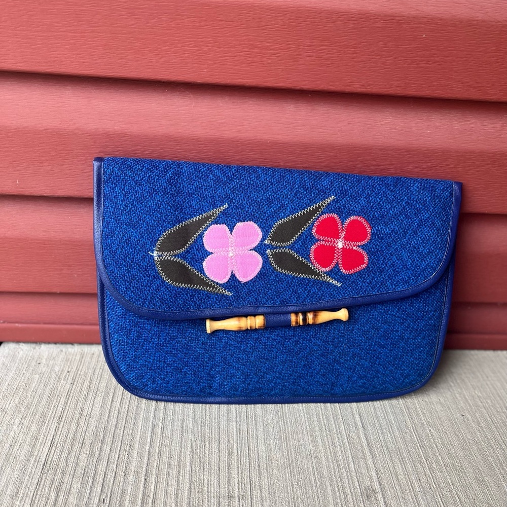Check out this adorable blue vintage floral envelope clutch with bamboo opening.
